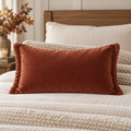AI-generated concept mockup of a rust-colored fall lumbar pillow